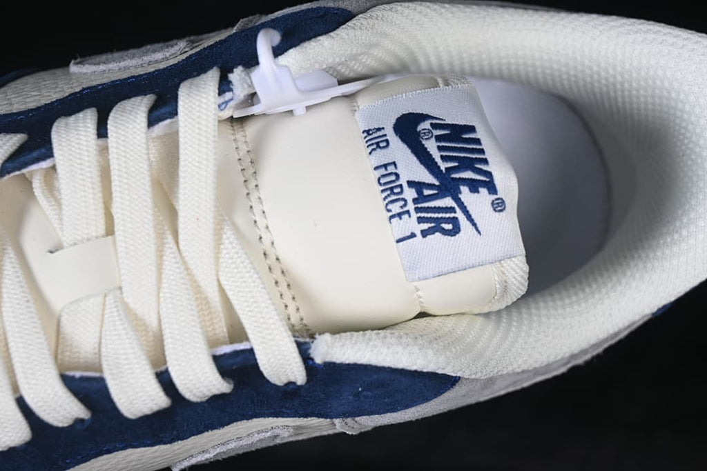 Top-down close-up of the tongue, white laces, and padded collar.