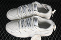 Pair of cream and gray Nike SB Dunk Low sneakers with patterned laces and heel cords