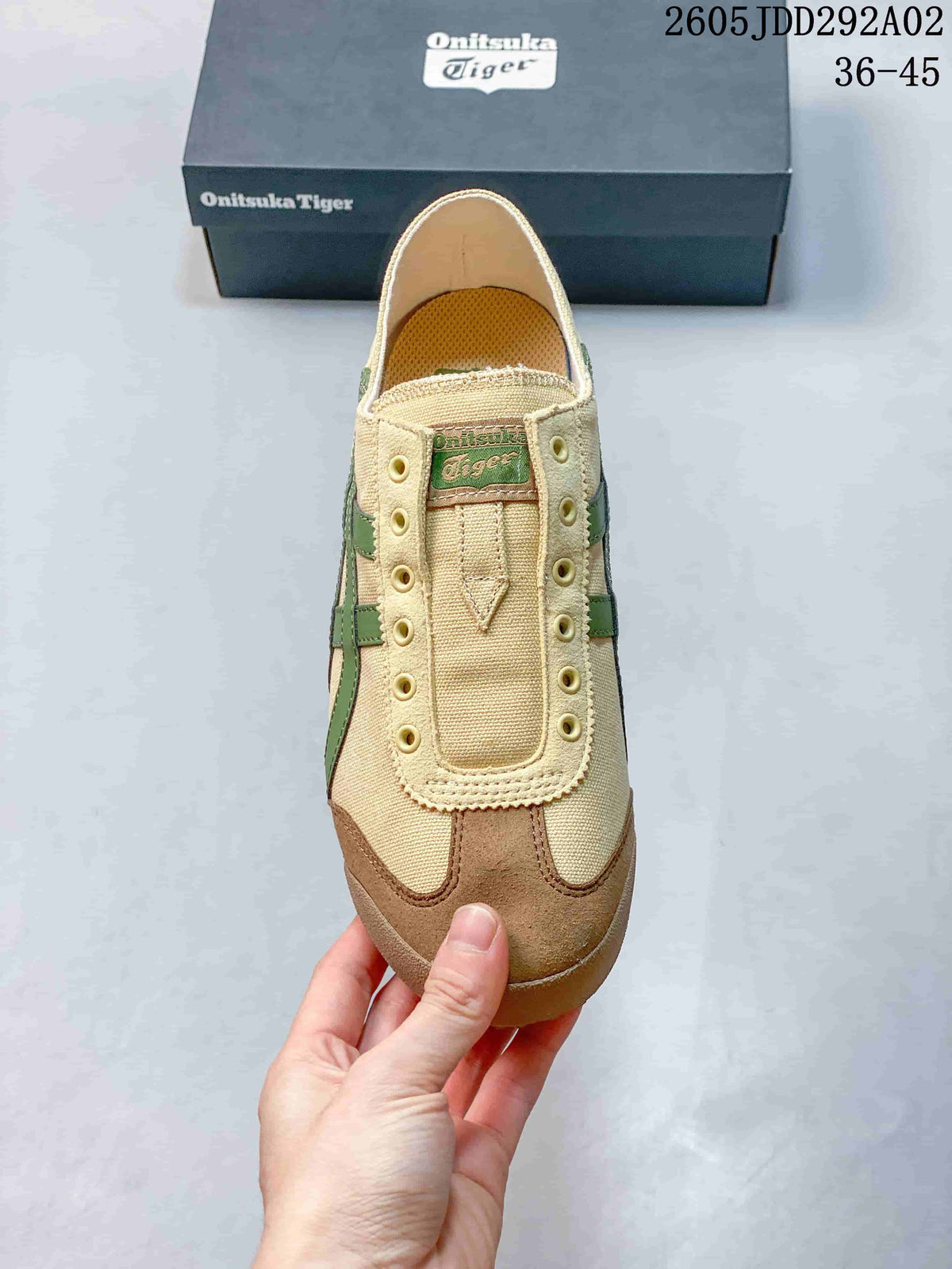Top view of the beige slip-on sneaker with decorative eyelets and a brown-toned toe overlay.