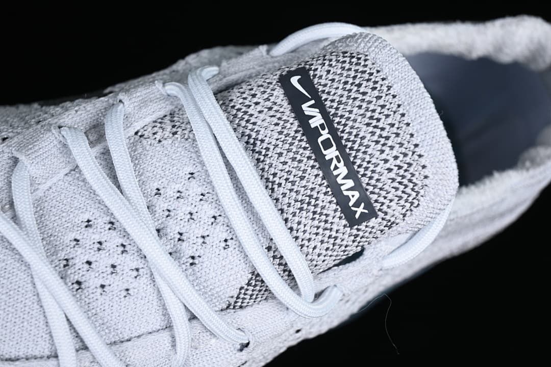 Close-up of the VaporMax tongue label, laces, and knit-patterned upper.