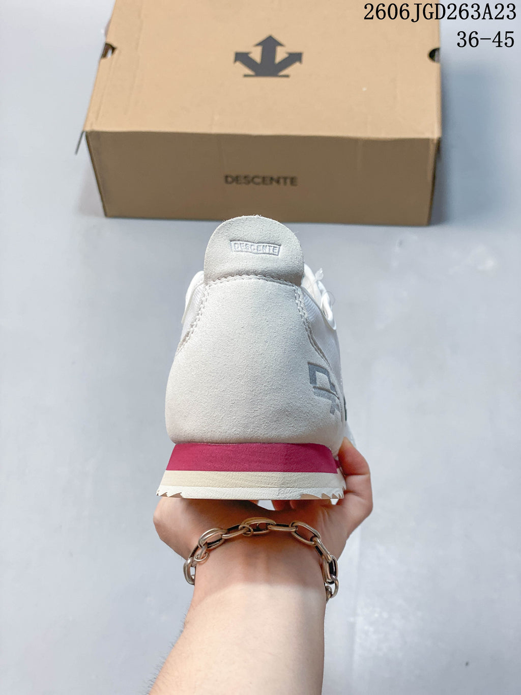 Rear view of the sneaker with a contrasting pink-red heel stripe
