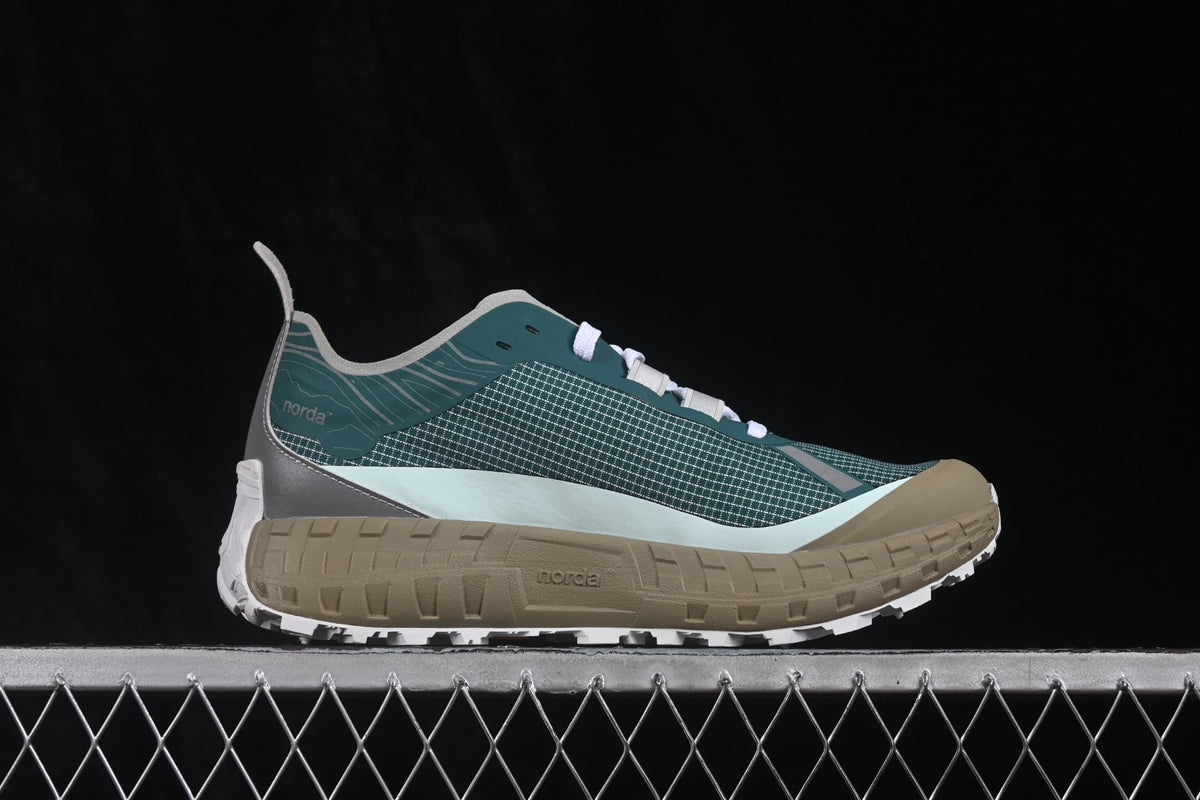 Side profile showing the green patterned upper, gray accents, tan midsole, and white outsole.