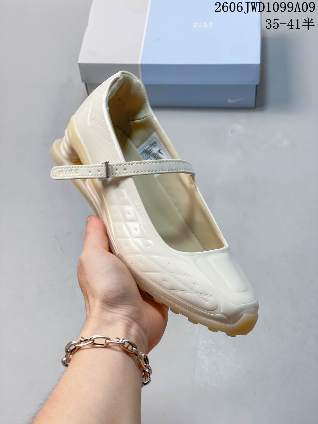 Angled view of an ivory Mary Jane sneaker showing its strap and side detailing