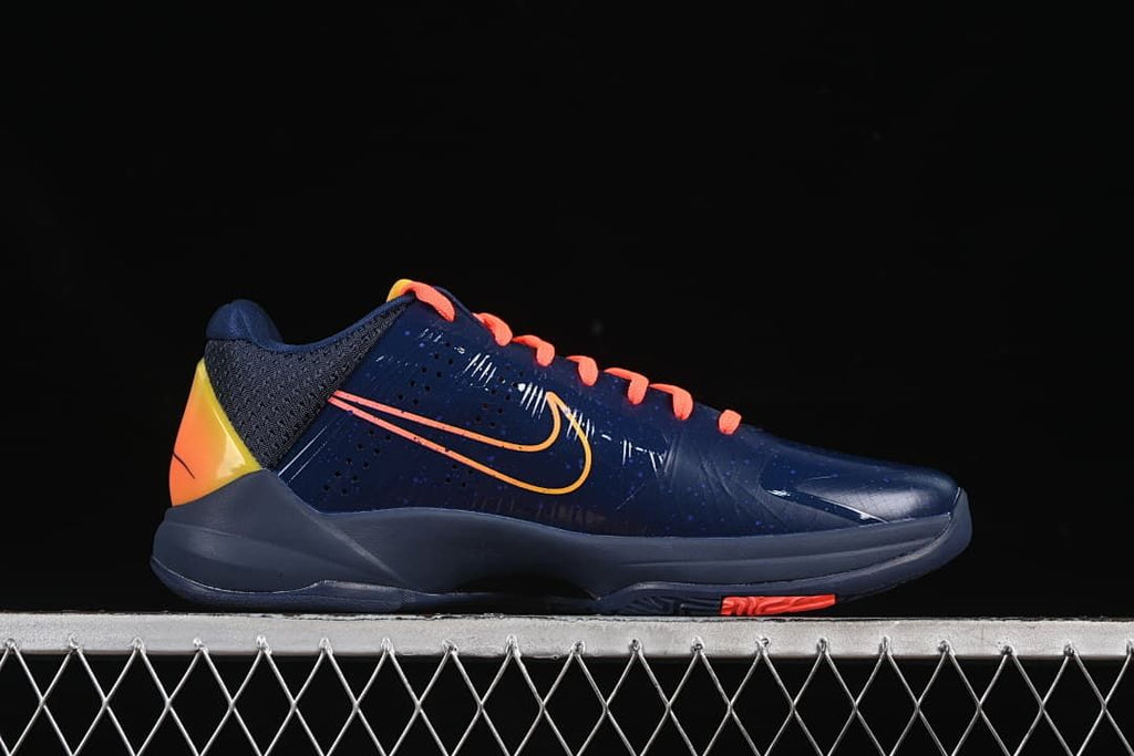 Side view highlighting the navy upper and contrast heel panel.