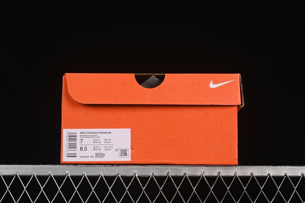 Orange shoe box with a label identifying Nike Pegasus Premium, style HQ2592-102, and sample sizes.