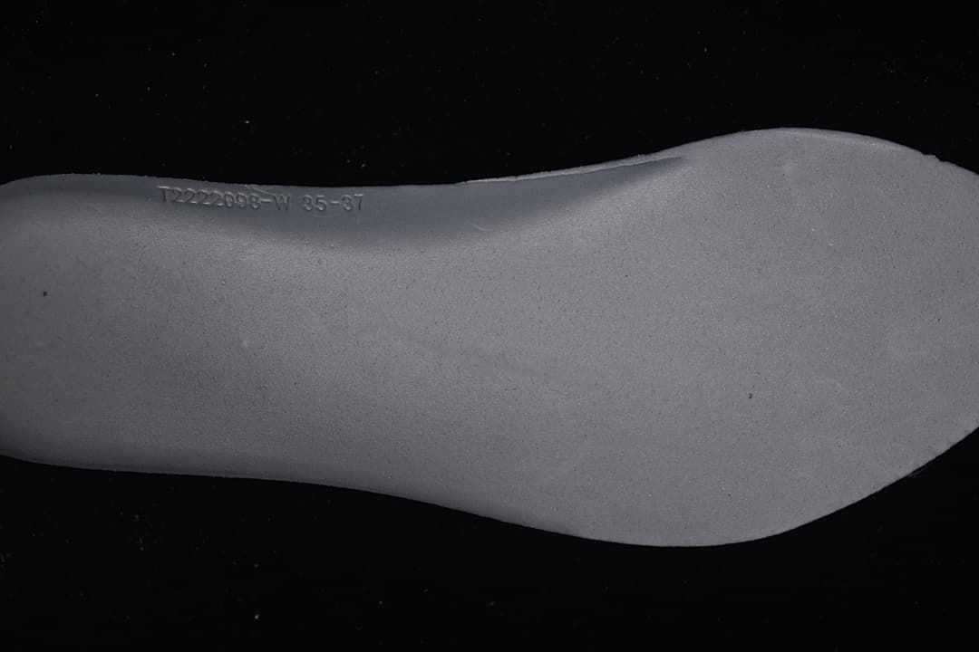 Close-up of the removable-looking gray insole underside with a printed marking
