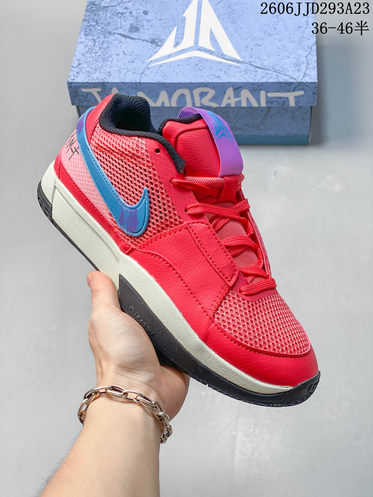 Bright red Nike Ja 1 EP shoe with blue and purple accents.