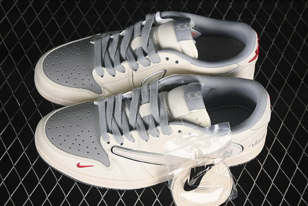 Top view of a pair of off-white and gray low-top sneakers with gray laces and an extra pair of light-colored laces.