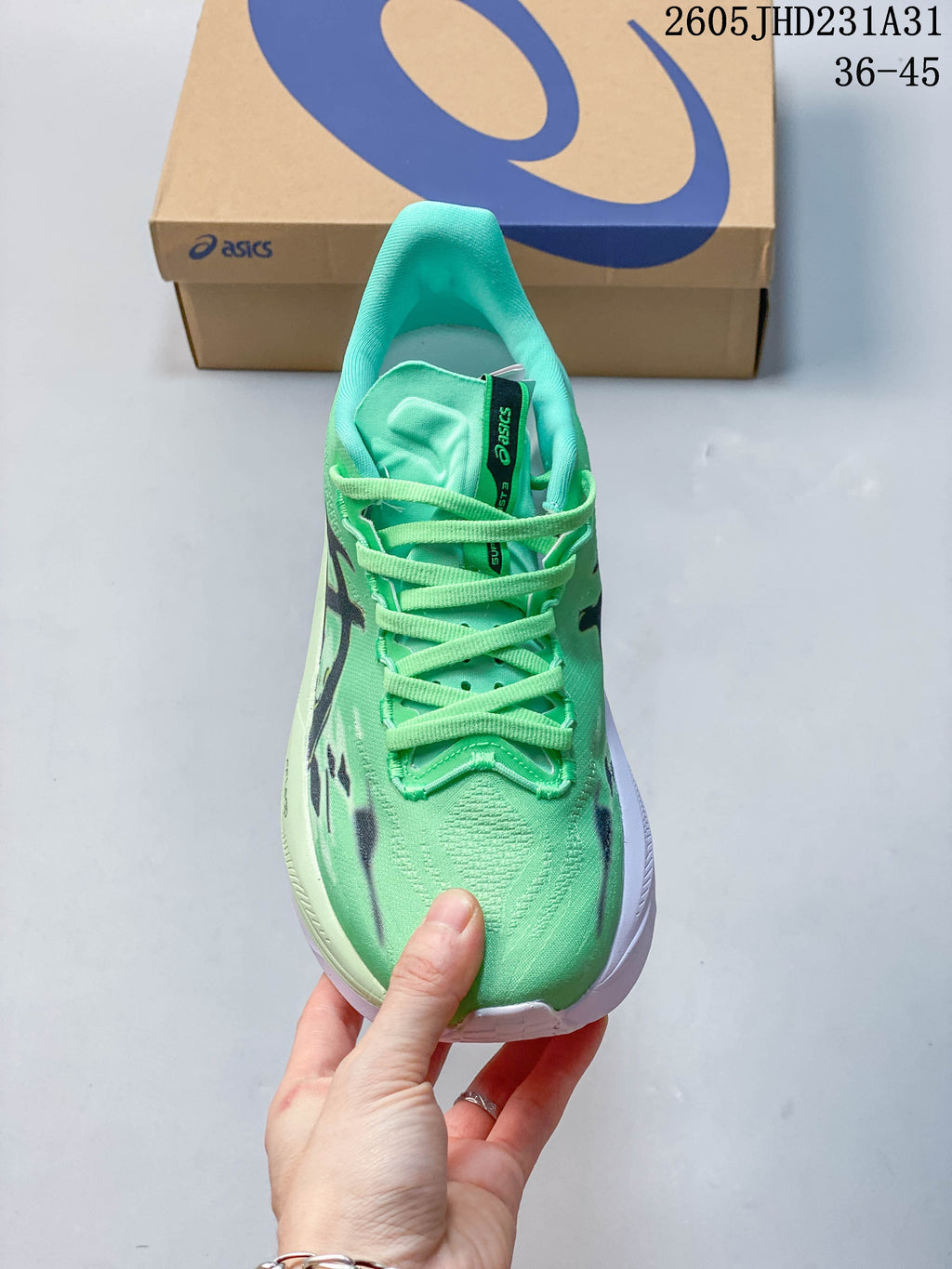Front view of the green lace-up running shoe