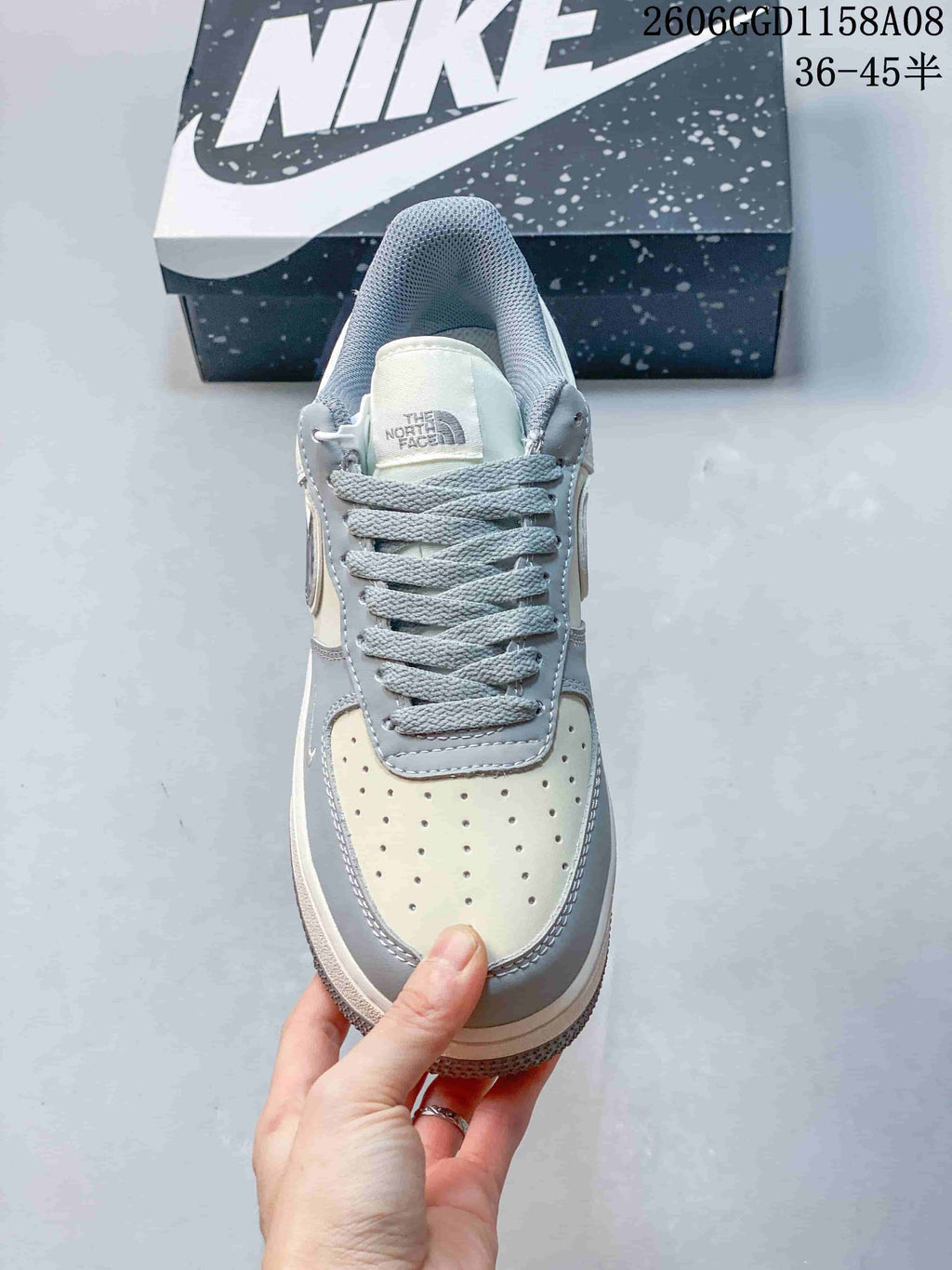 Front view of the sneaker showing gray laces and a perforated toe