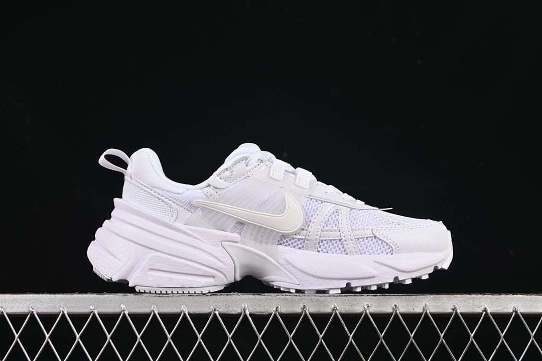 Side profile of the white sneaker showing its layered design and chunky sole.