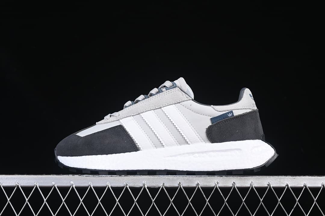 Side profile of a single gray, white, and charcoal sneaker