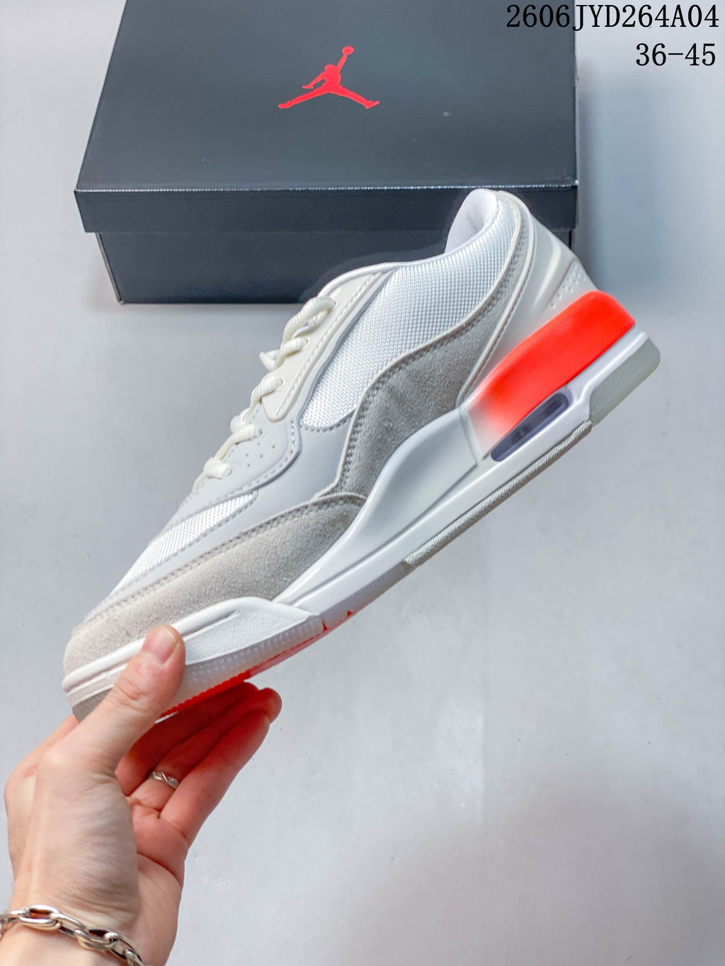 Side profile of a sail and gray Jordan sneaker with a visible heel detail