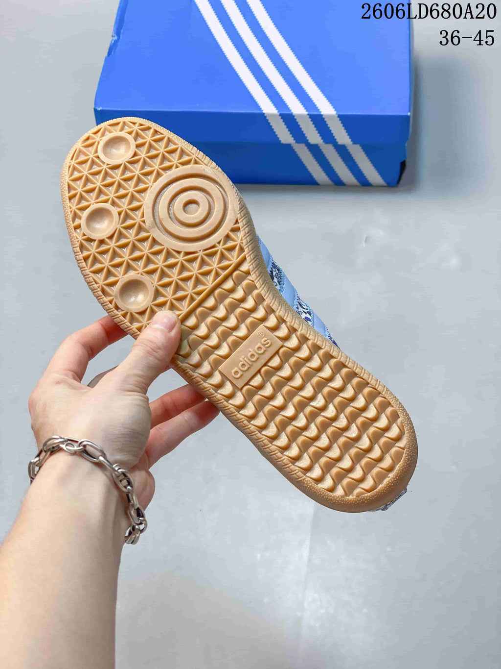 Underside of a sneaker showing a gum-colored outsole with textured tread.