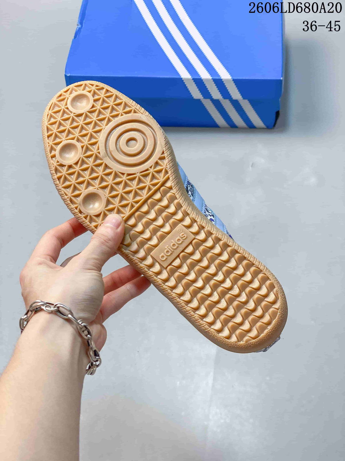 Underside of a sneaker showing a gum-colored outsole with textured tread.