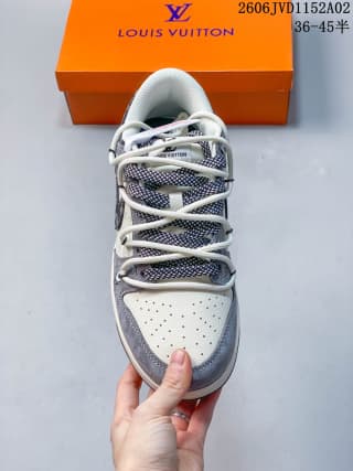 Top-down view of the sneaker showing the white perforated toe box, gray overlays, patterned tongue area, and white laces.