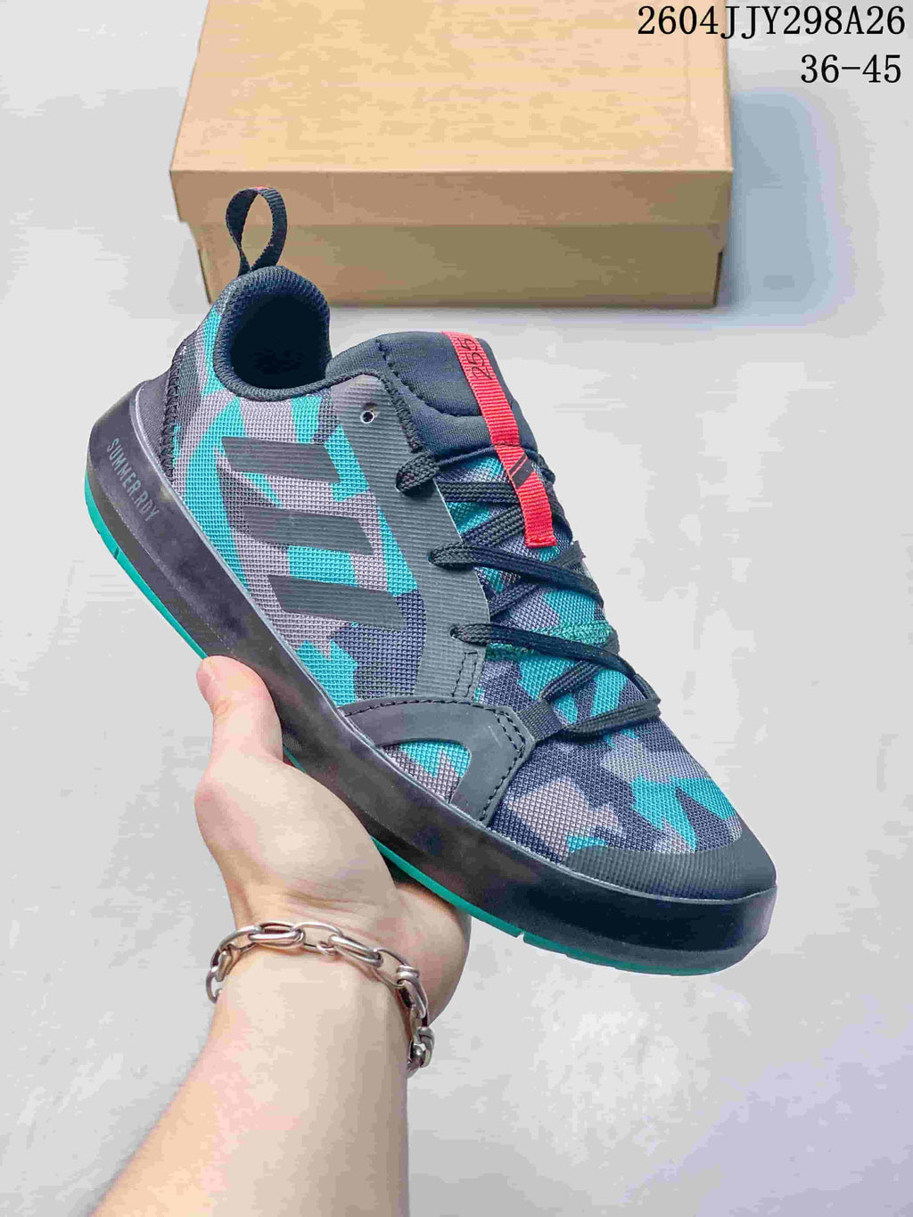 Dark gray and teal patterned Adidas Terrex Boat shoe with a red lace detail.