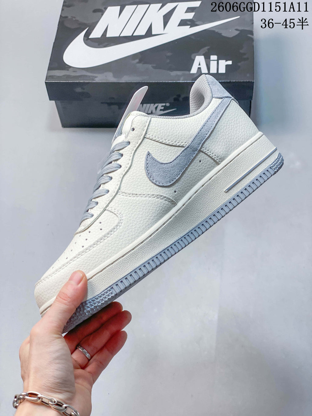 Side profile showing gray Swoosh and off-white upper