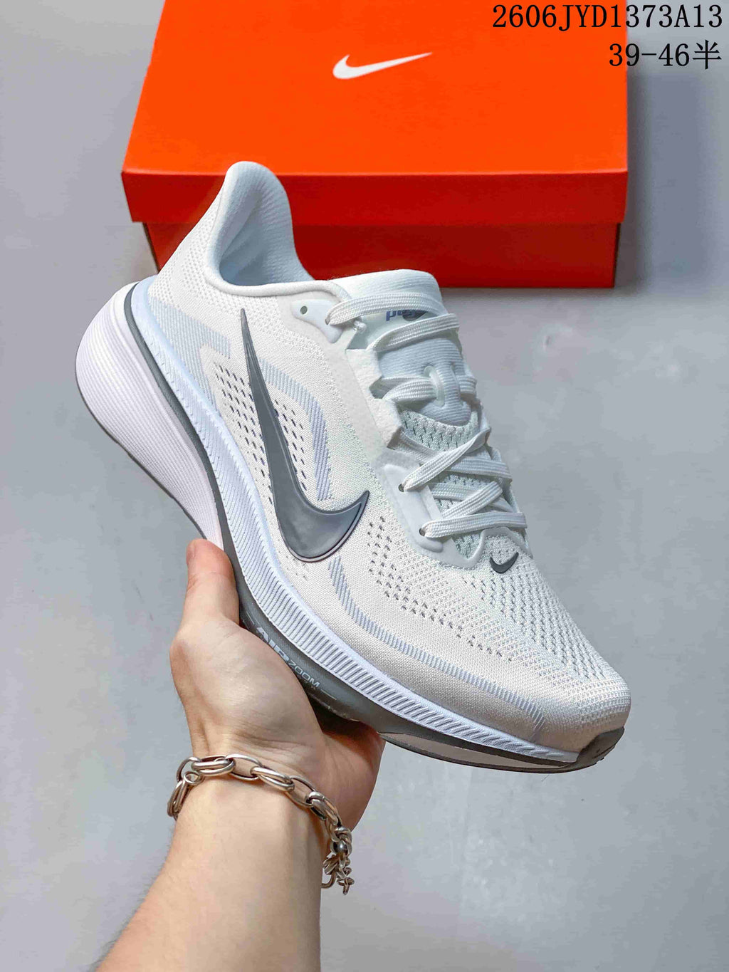 Angled side view of a white Nike Pegasus 42 running shoe with gray accents