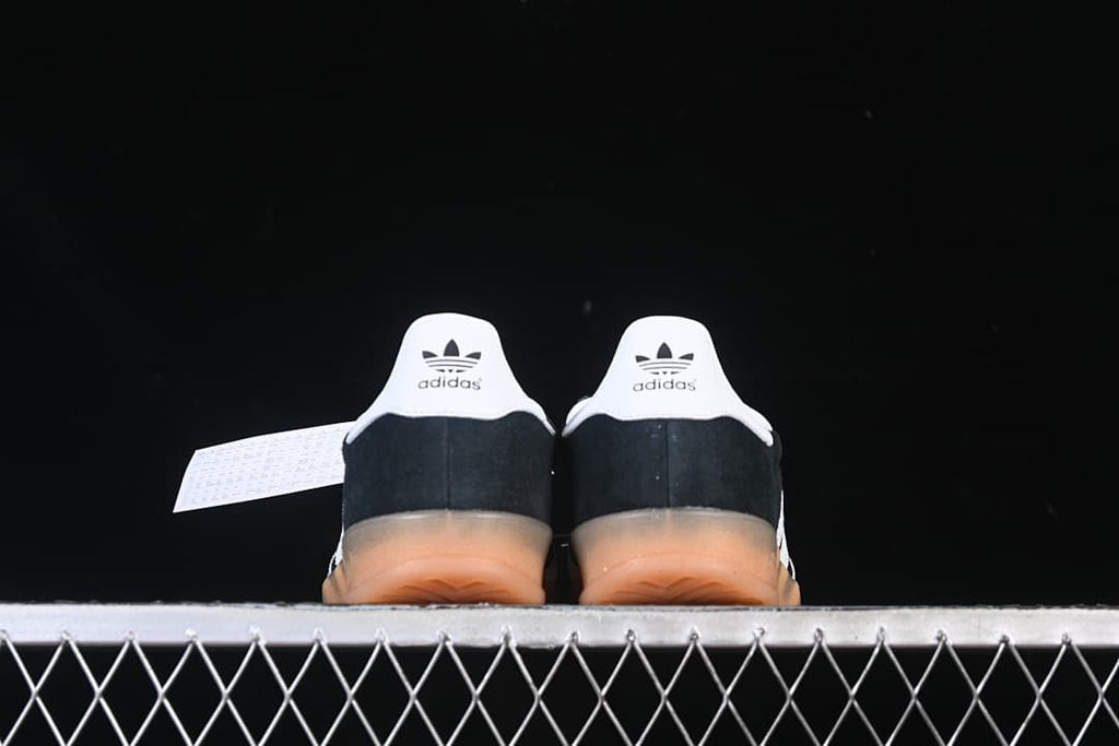 Rear view of both sneakers showing white heel tabs and translucent gum-colored soles.