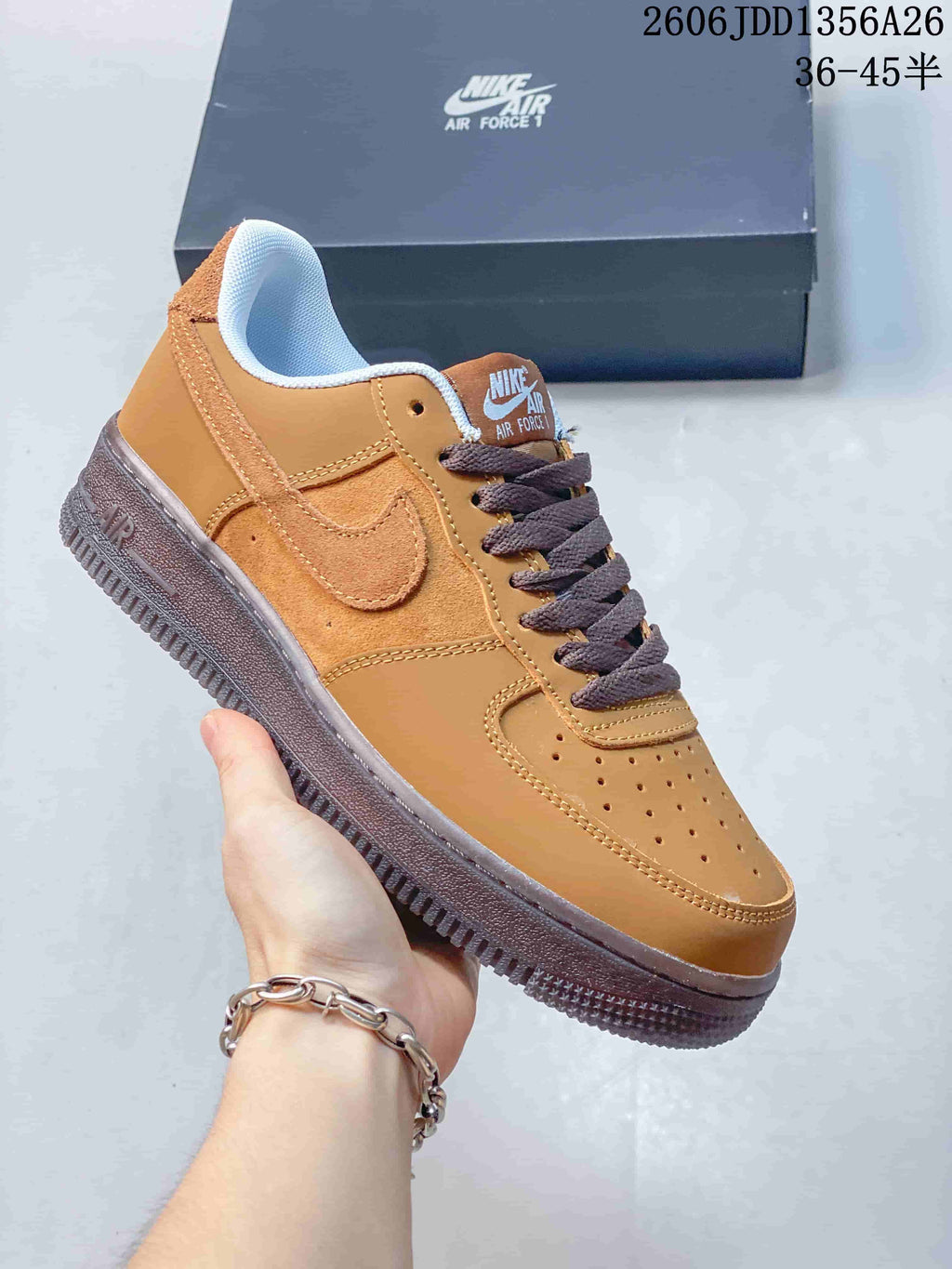 Tan Nike Air Force 1 low-top sneaker with brown laces and contrasting outsole