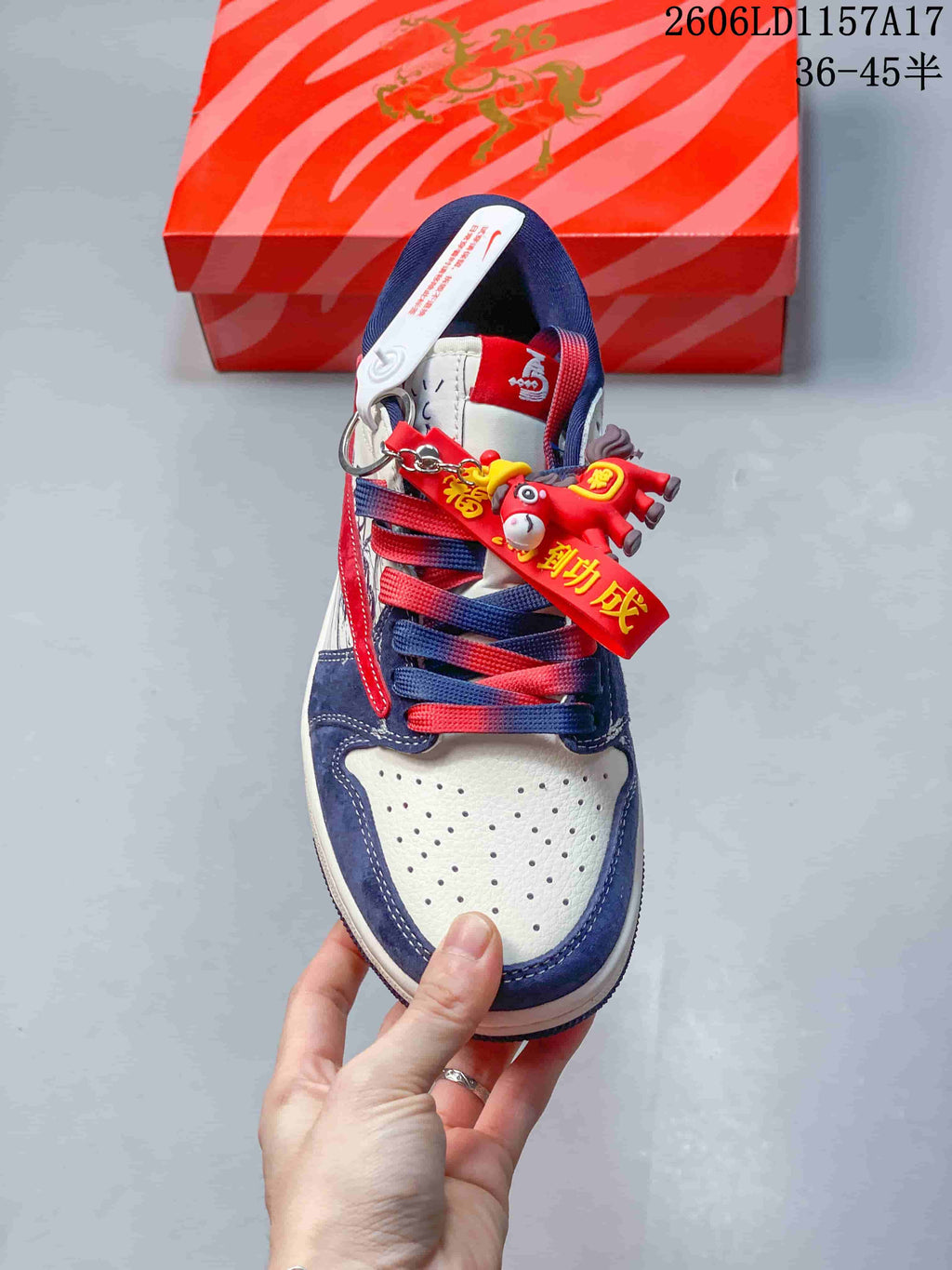 Top view showing the perforated white toe, navy overlays, two-tone laces and decorative charms.