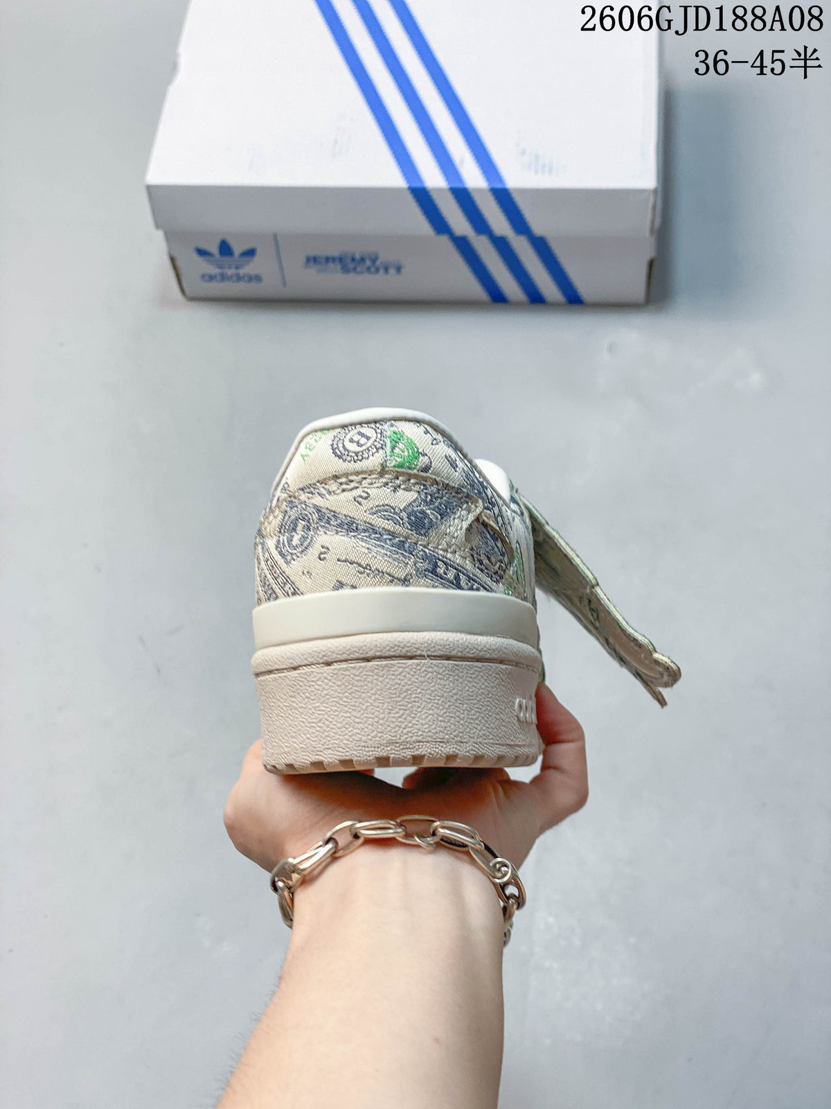 Rear view of the banknote-print low-top sneaker with light-colored heel and sole