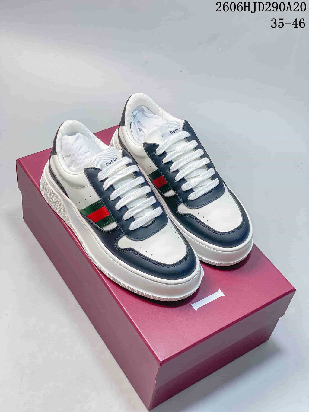 Pair of white and navy Gucci Chunky low-top sneakers with green-and-red side stripes