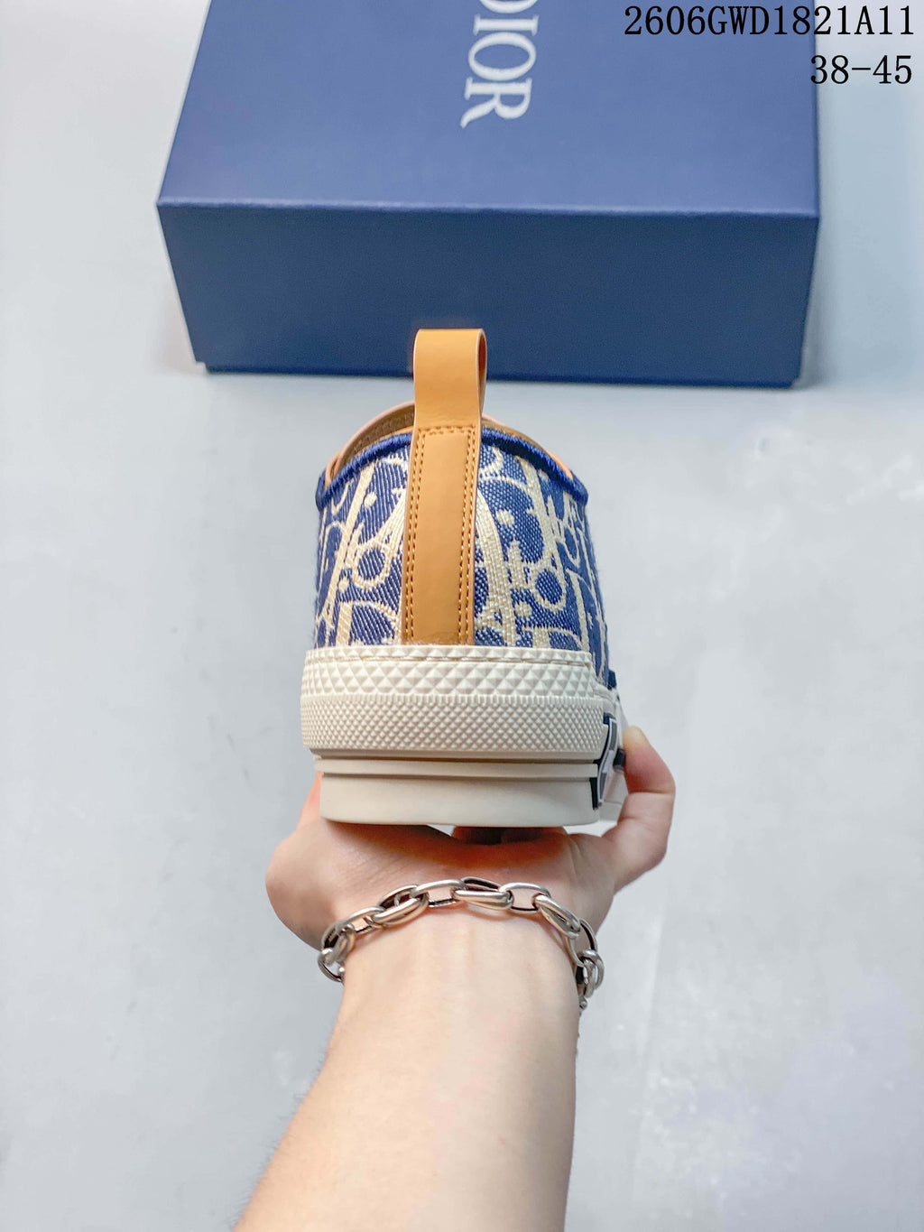 Rear view of a patterned sneaker with a tan heel pull tab and cream-colored sole