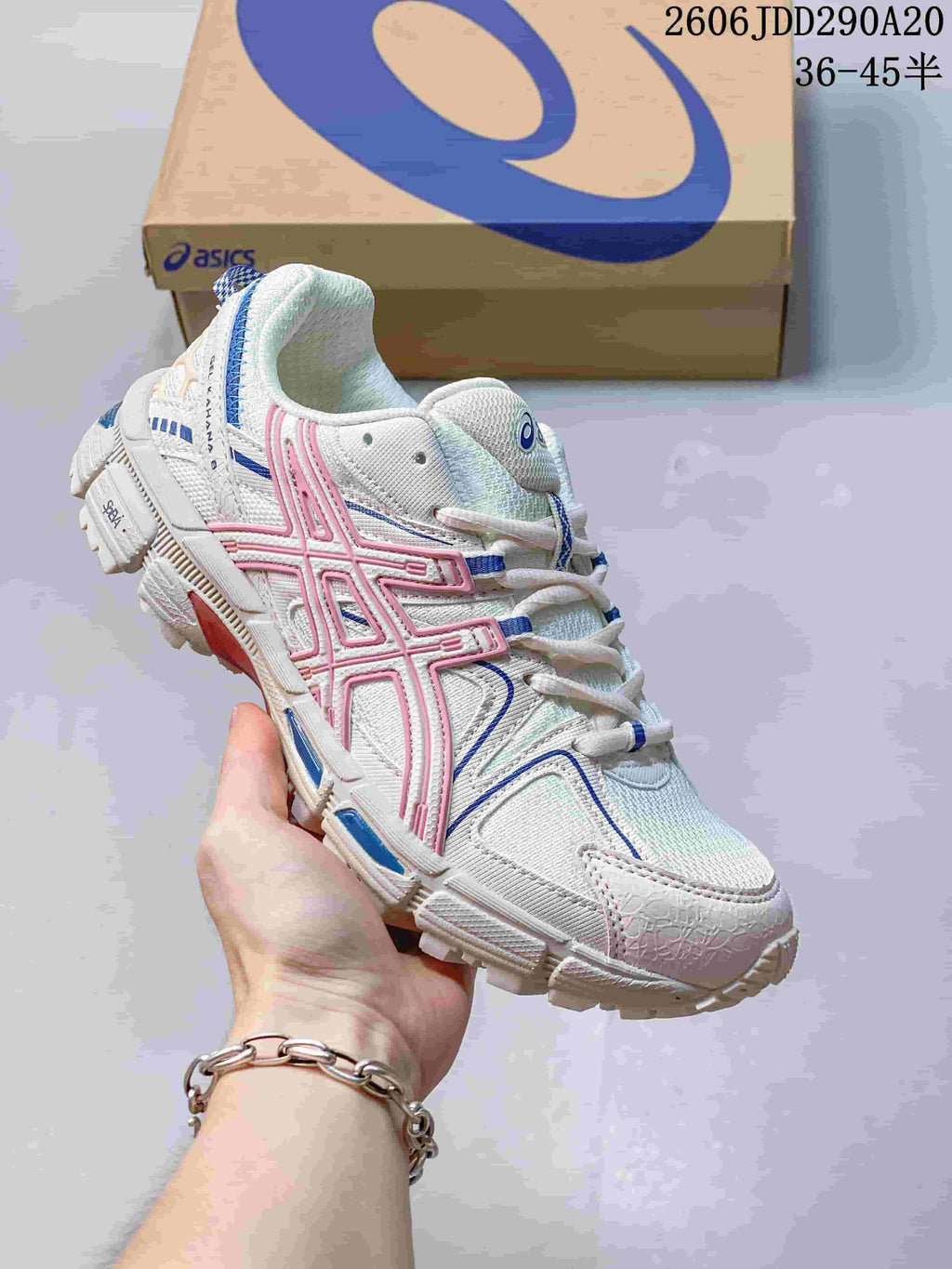 Close-up of a white ASICS Gel-Kahana 8 sneaker with pink and blue accents.