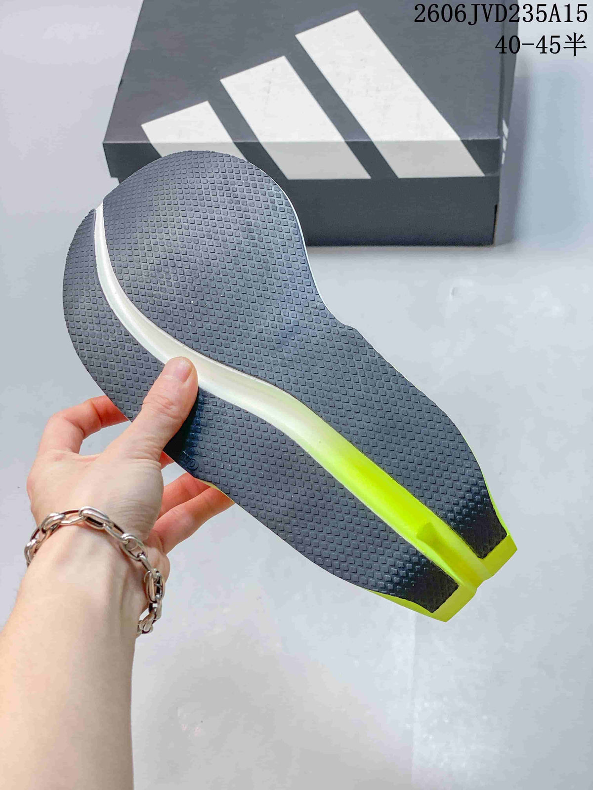 Close-up of the dark textured outsole with a neon green central section