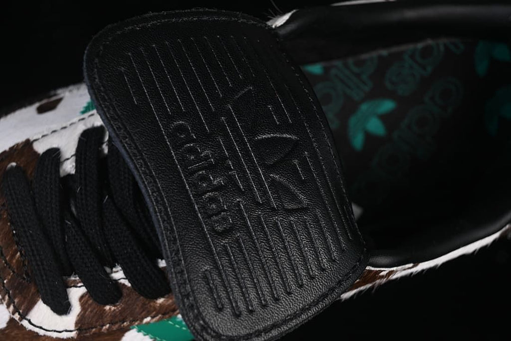 Close-up of the black fold-over tongue flap and patterned insole