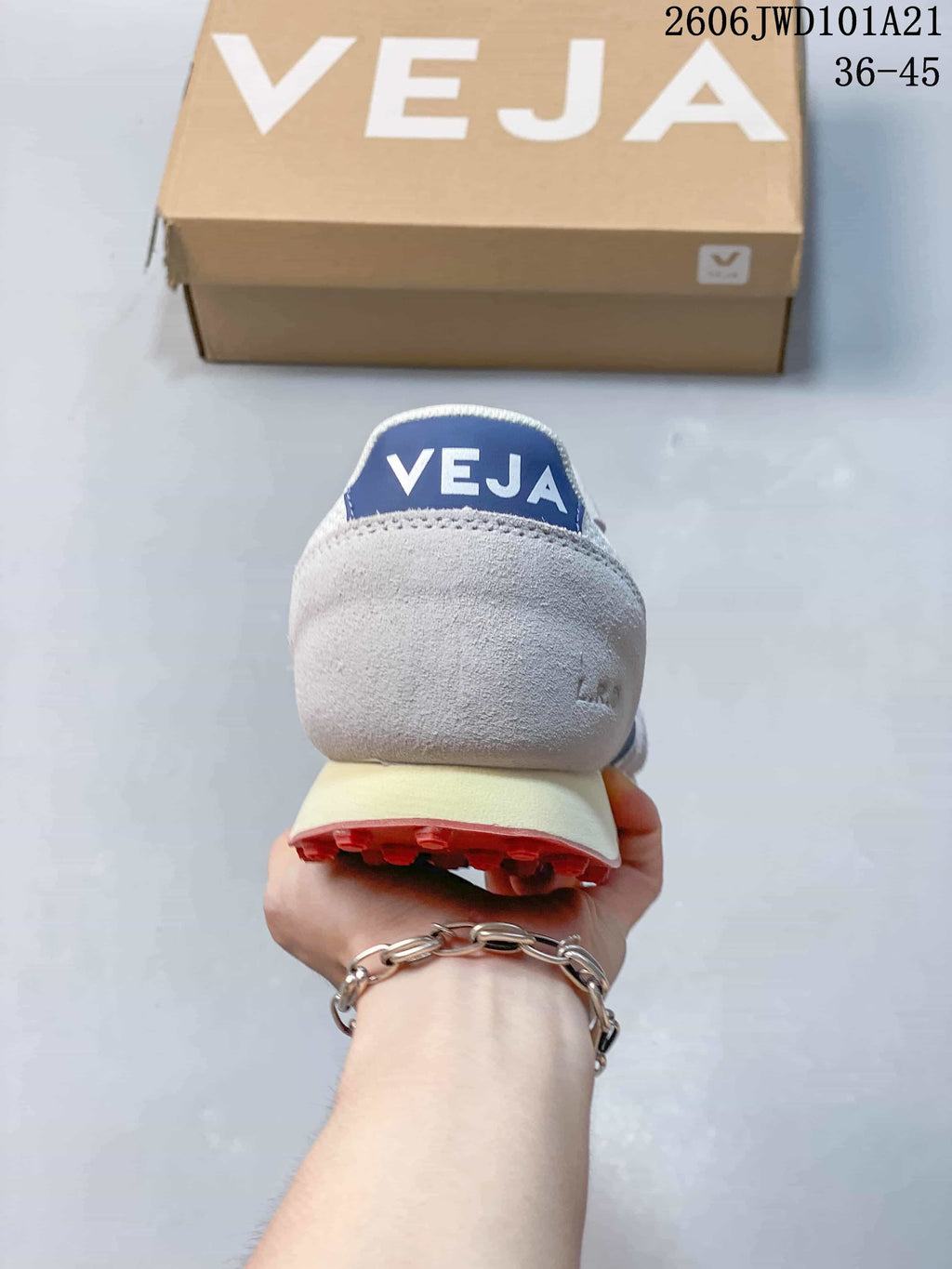 Rear view of a Veja sneaker with a blue heel tab and cream-colored midsole