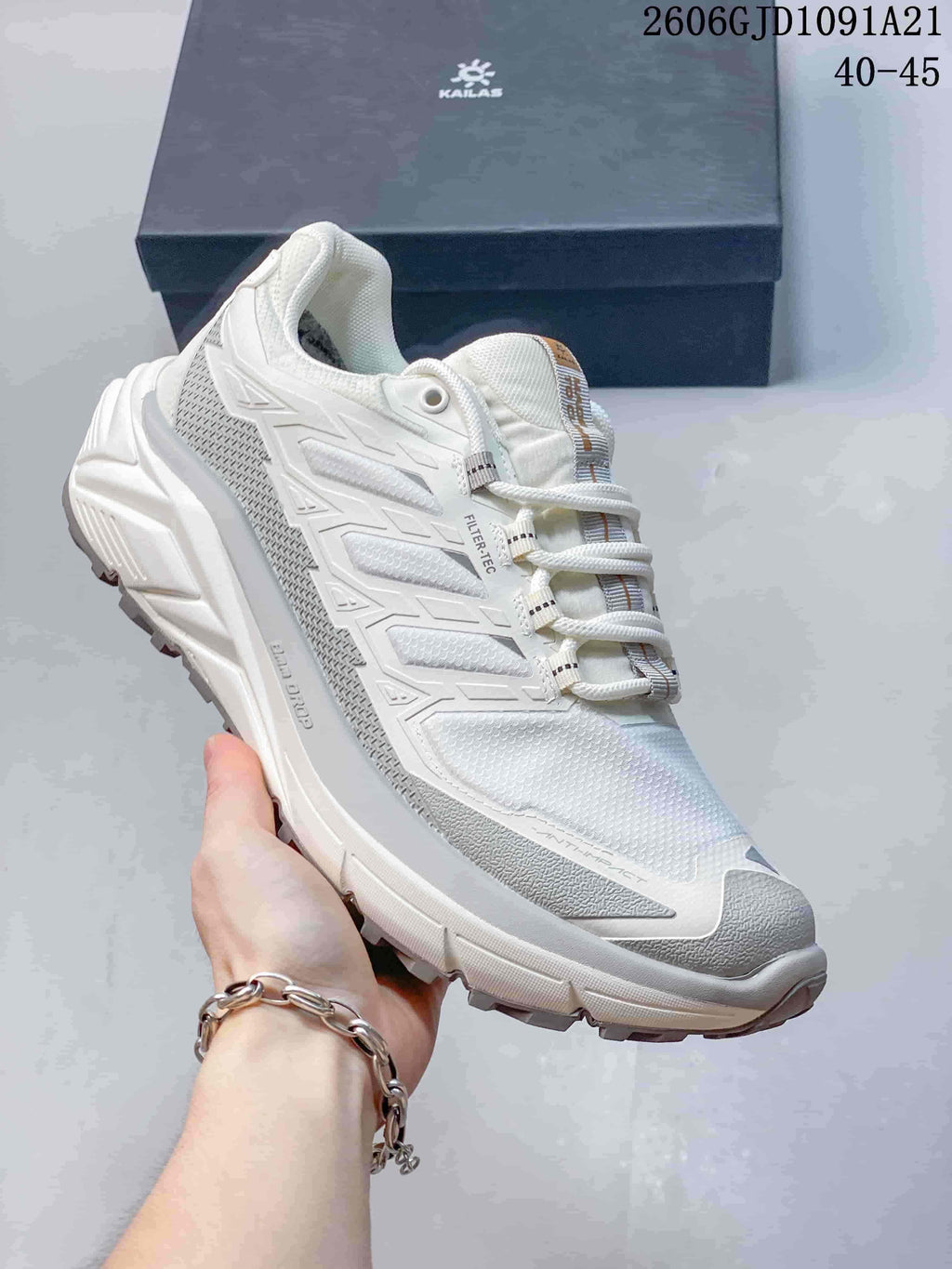 Angled side view of the white Kailas trail running shoe