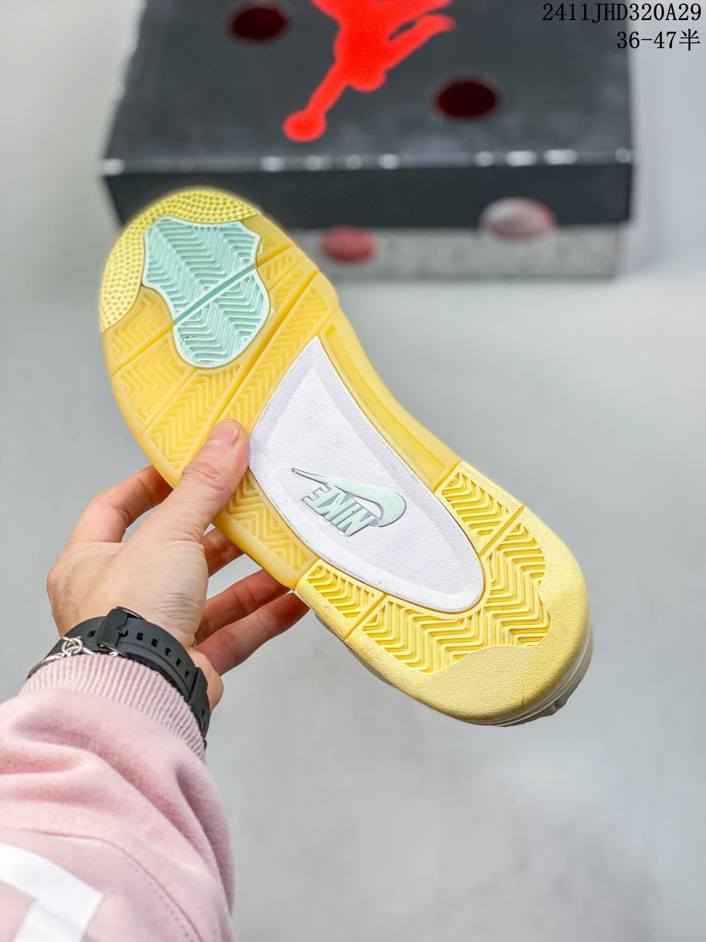 Underside of the sneaker showing a yellow-toned patterned outsole and contrasting center panel.