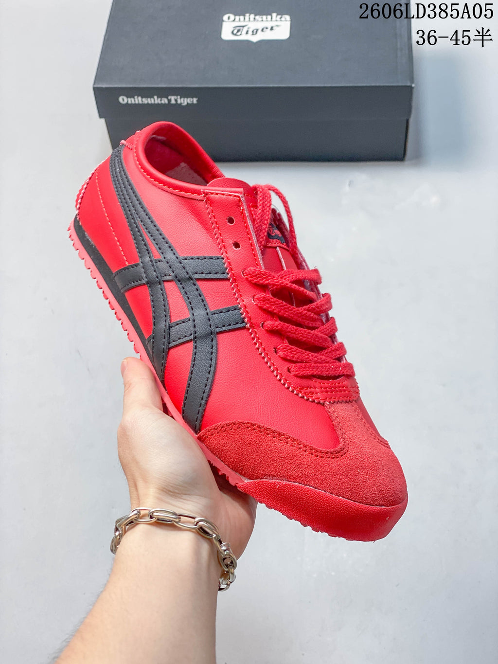 Angled side view of the red and dark-accented sneaker