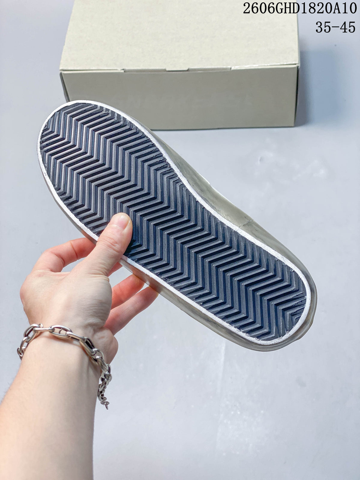 Close-up of the sneaker outsole showing a dark zigzag tread pattern.