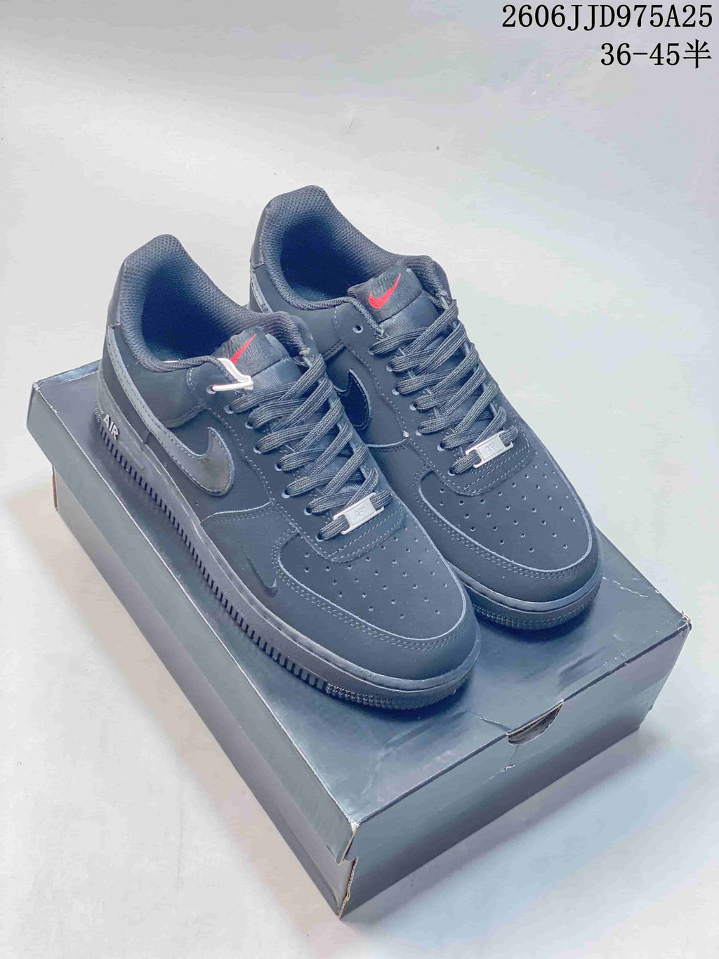 Dark gray low-top sneakers with perforated toe panels and contrasting Swoosh details