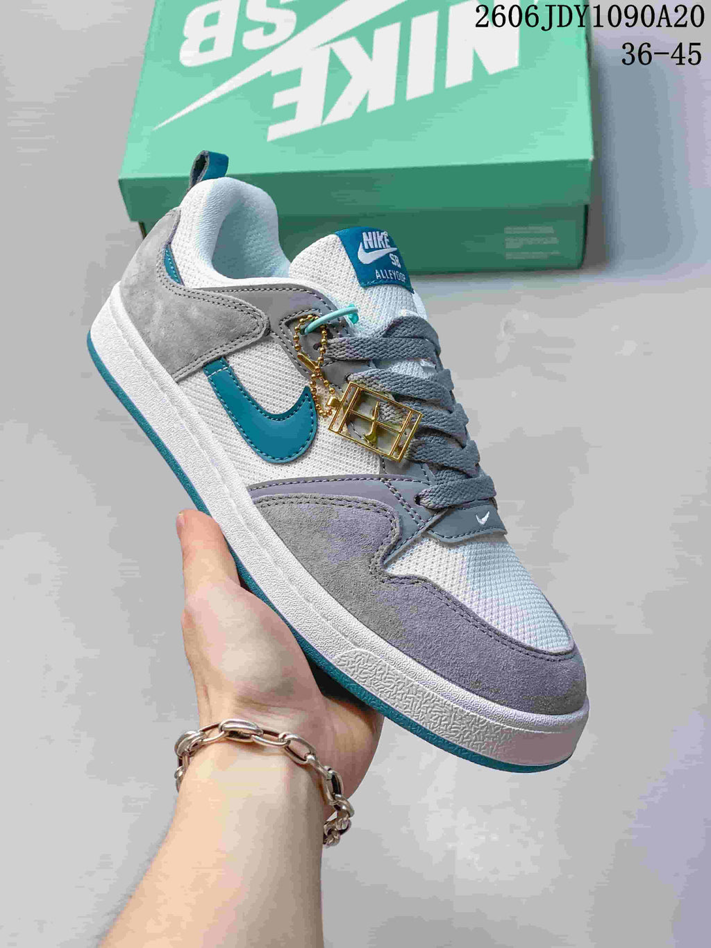 Angled side view showing the teal Swoosh and contrasting gray panels