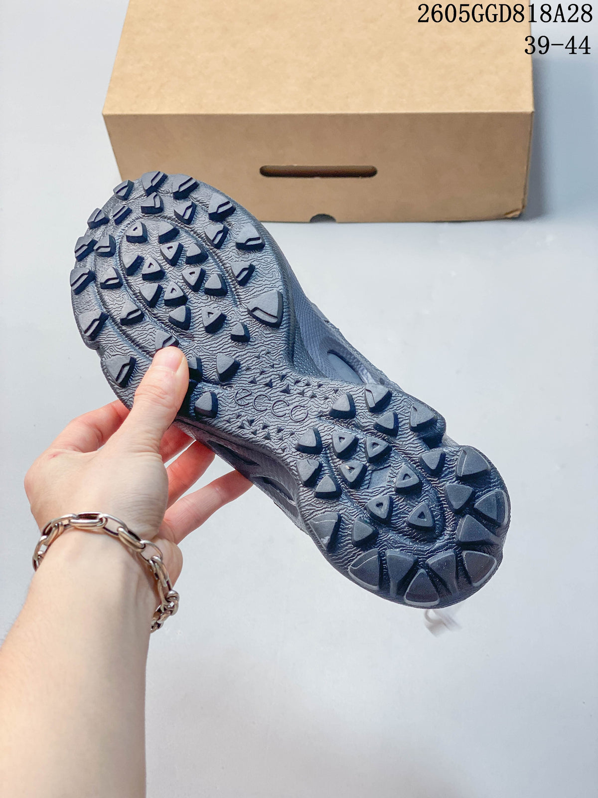 Close-up of the gray sneaker outsole showing its lugged tread