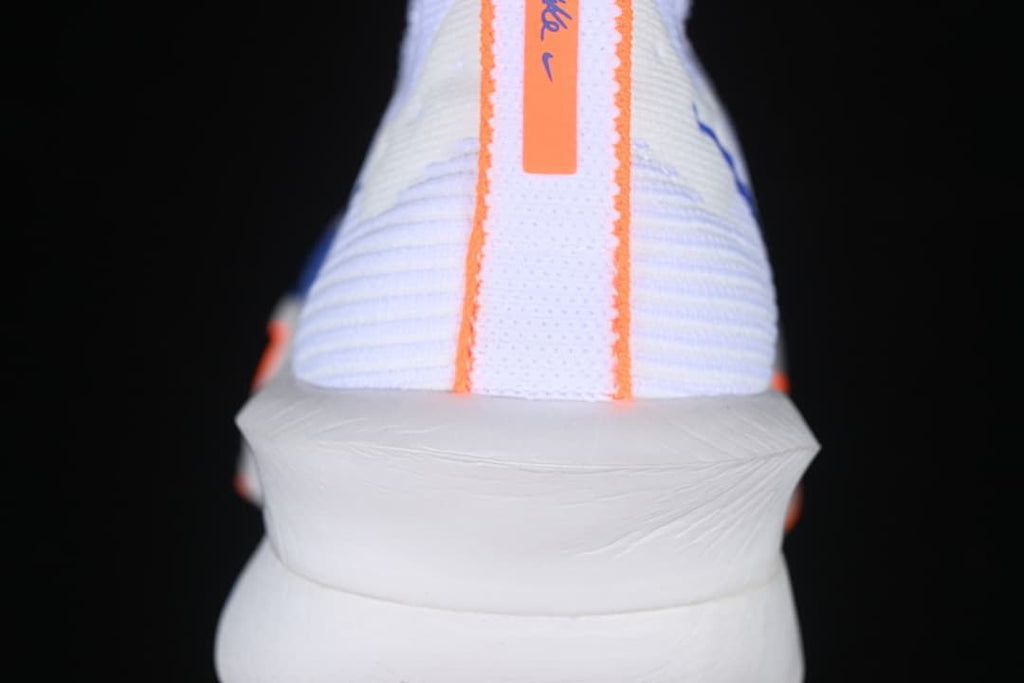 Rear view of the shoe with orange detailing along the heel.