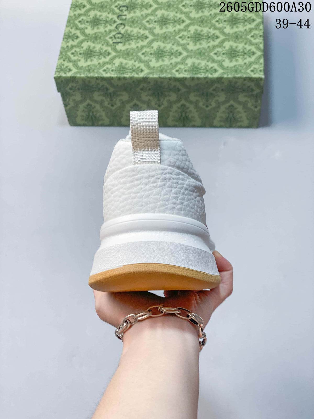 Rear view showing the textured white heel and gum-colored outsole.
