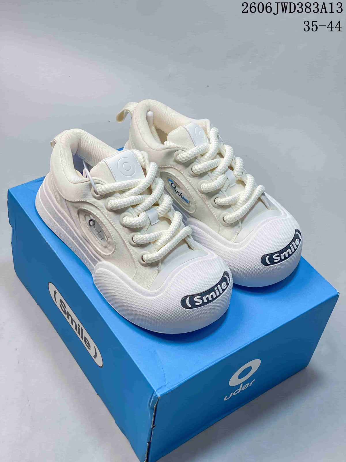 Pair of white Ocai 002 Smile low-top sneakers with chunky laces and rounded toe badges