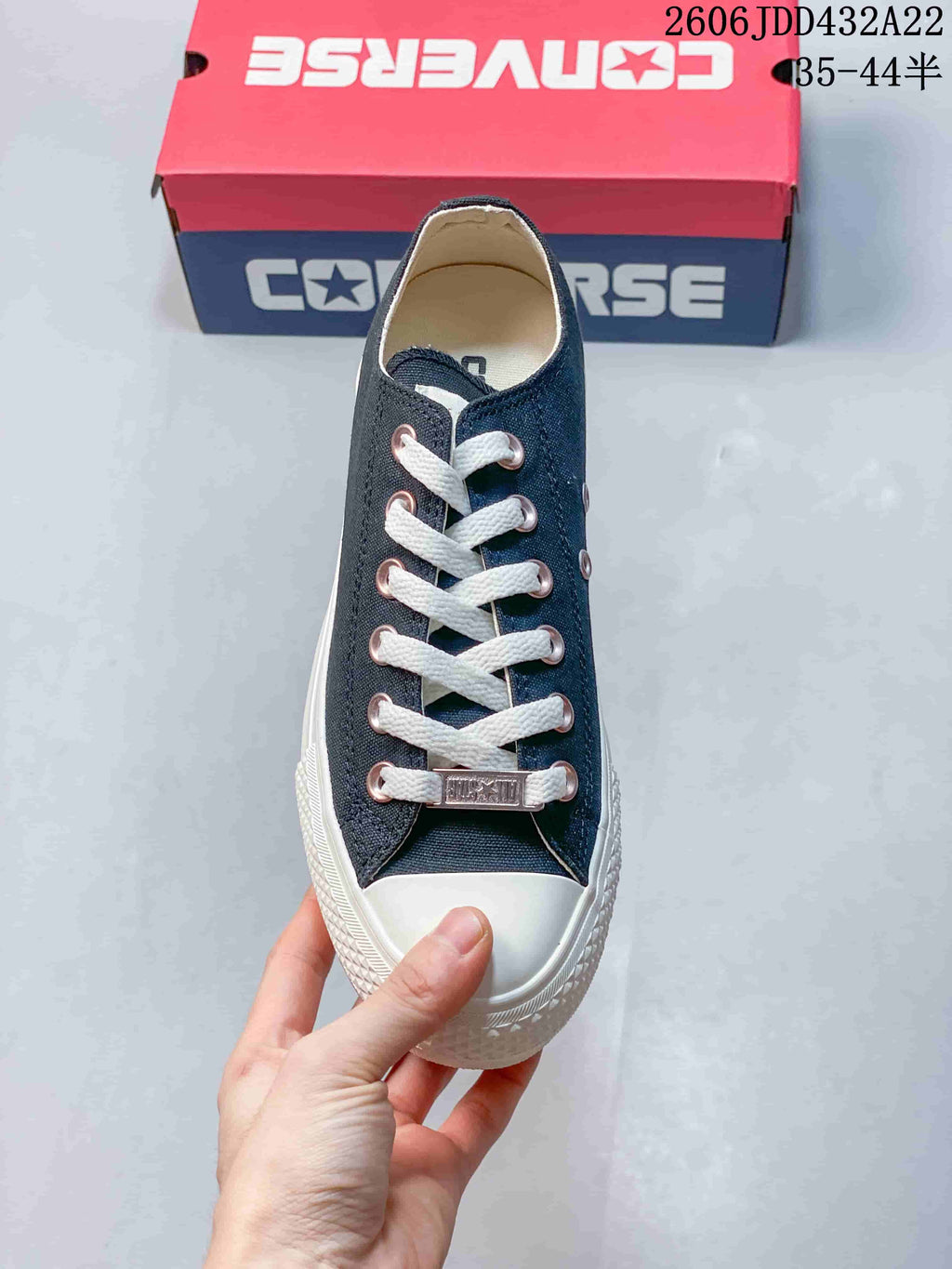 Top view of a navy Converse All Star sneaker with white laces and toe cap
