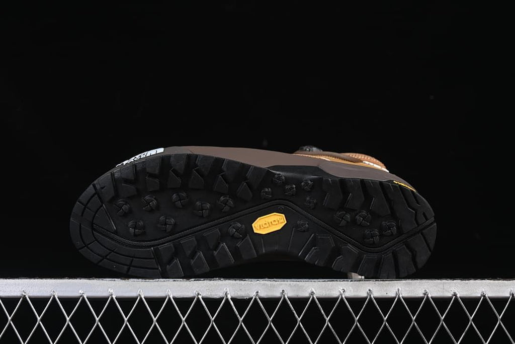 Underside of shoe showing black lugged outsole