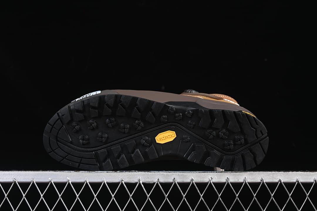 Underside of shoe showing black lugged outsole