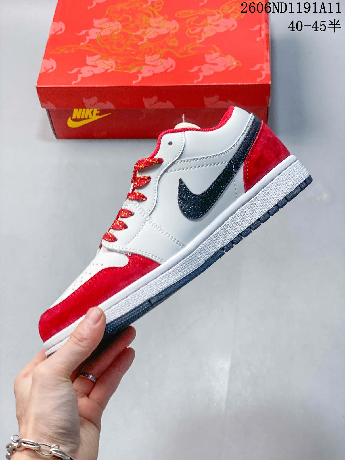 Side view of the white and red low-top sneaker with a dark Swoosh, red overlays, and patterned laces.