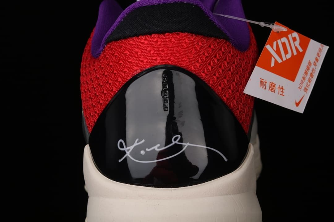 Rear view of the shoe with red fabric, purple lining, and signature heel panel