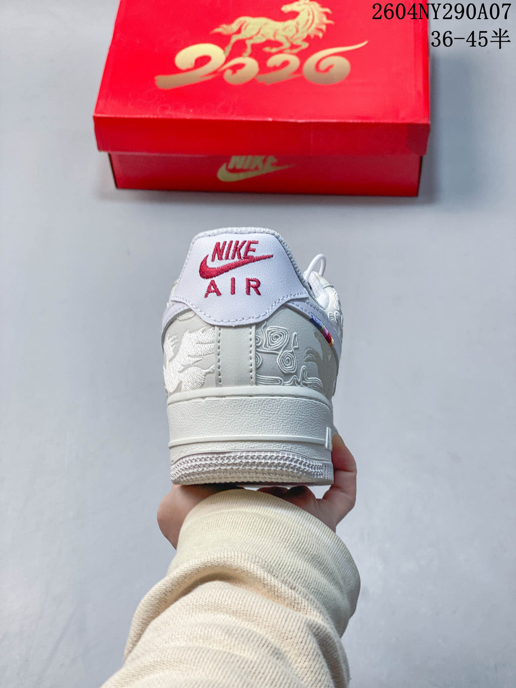 Rear view of the white Air Force 1 showing embroidered horse-themed heel panels