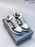 Pair of white, navy, and gray Nike SB Dunk Low sneakers with red accents on a shoe box